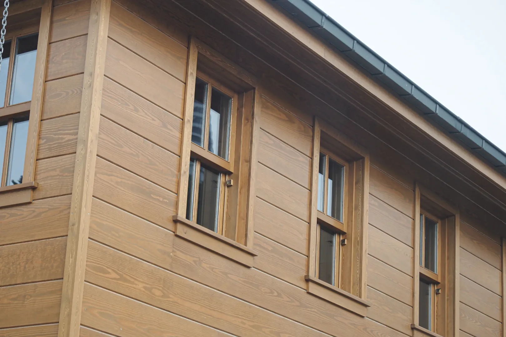 Modern home exterior featuring engineered wood siding with natural wood appearance